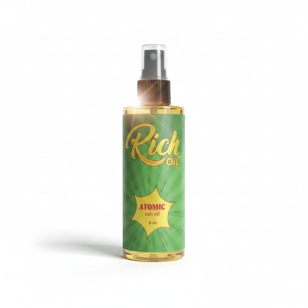 The Rich Oil Atomic Sun Maximizer Tanning Oil in a clear spray bottle with a green label, promoting a golden tan and Vitamin D synthesis.