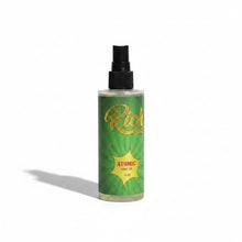 Load image into Gallery viewer, The Rich Oil Atomic tanning oil in a clear bottle with a green label featuring sunburst rays and gold text. Supports Vitamin D conversion and skin hydration.
